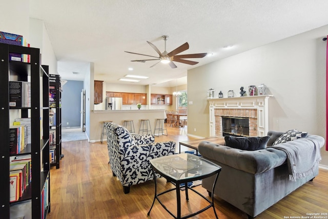 11823 Stanton, San Antonio, TX 78253 - living area featuring light wood-style floors, ceiling fan, baseboards, and a fireplace