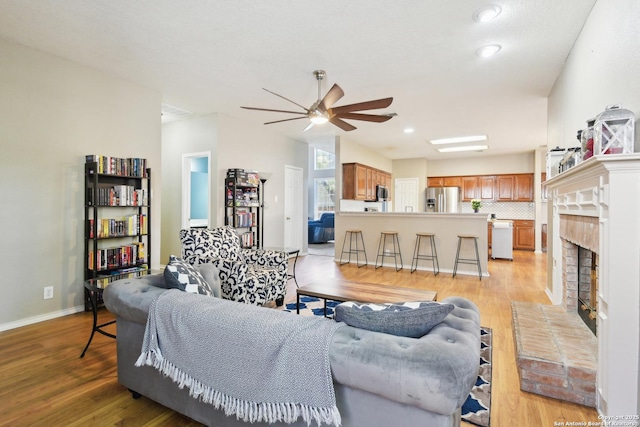 11823 Stanton, San Antonio, TX 78253 - living area with a ceiling fan, light wood-type flooring, a brick fireplace, baseboards, and recessed lighting