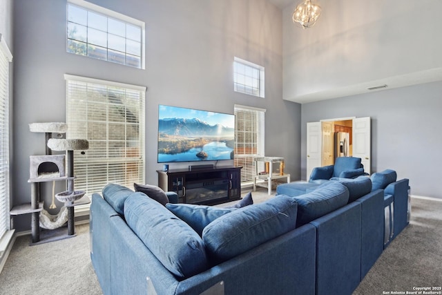 11823 Stanton, San Antonio, TX 78253 - carpeted living area with a towering ceiling, a chandelier, and baseboards