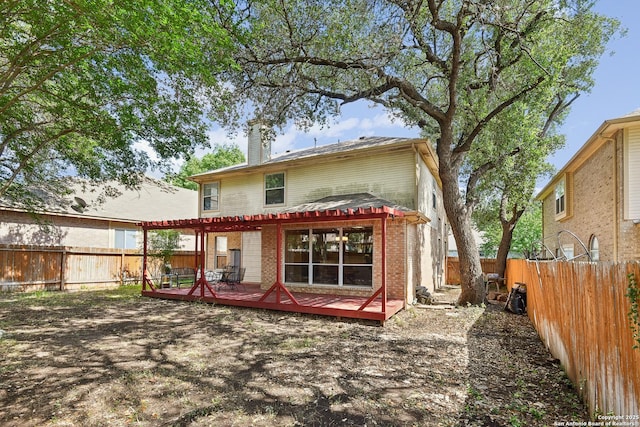 11823 Stanton, San Antonio, TX 78253 - back of property featuring a chimney, a wooden deck, a fenced backyard, and brick siding