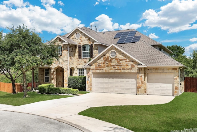 25511 Willard Path, San Antonio, TX 78261 - traditional home with stone siding, driveway, roof with shingles, solar panels, and a garage
