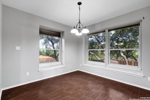 25511 Willard Path, San Antonio, TX 78261 - spare room with baseboards, dark wood-style flooring, and a chandelier