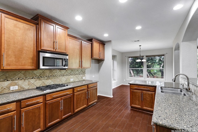 25511 Willard Path, San Antonio, TX 78261 - kitchen with stainless steel appliances, a sink, decorative backsplash, baseboards, and stone counters