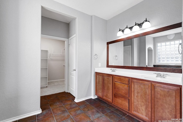 25511 Willard Path, San Antonio, TX 78261 - full bathroom with double vanity, baseboards, a walk in closet, and tile patterned floors