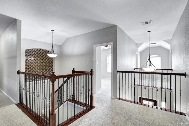 25511 Willard Path, San Antonio, TX 78261 - hall featuring lofted ceiling, an upstairs landing, a textured wall, carpet, and baseboards