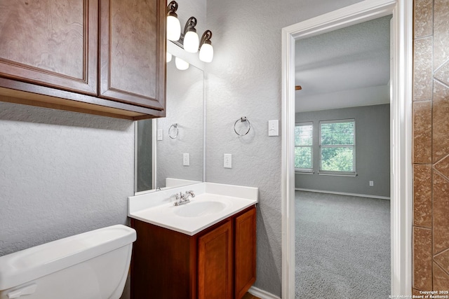 25511 Willard Path, San Antonio, TX 78261 - bathroom featuring vanity, toilet, a textured wall, and baseboards
