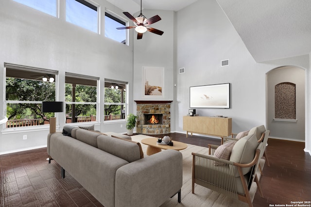25511 Willard Path, San Antonio, TX 78261 - living area with high vaulted ceiling, baseboards, arched walkways, a ceiling fan, and plenty of natural light