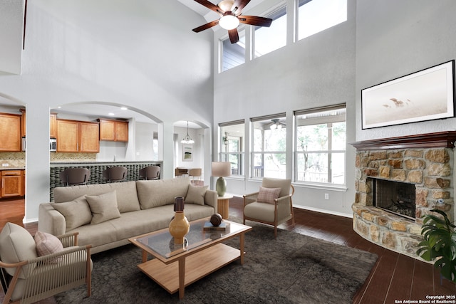 25511 Willard Path, San Antonio, TX 78261 - living room with a ceiling fan, arched walkways, dark wood-type flooring, plenty of natural light, and a towering ceiling