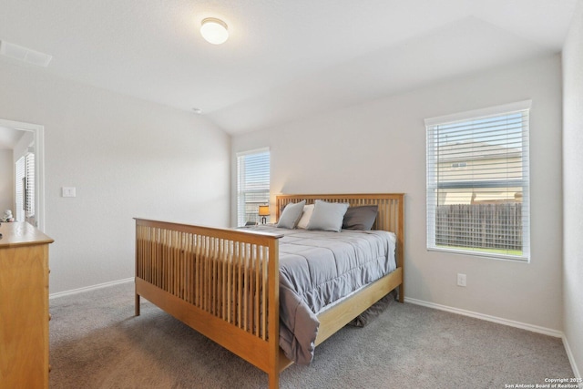 6131 Akin, San Antonio, TX 78261 - bedroom with multiple windows, carpet, baseboards, and vaulted ceiling