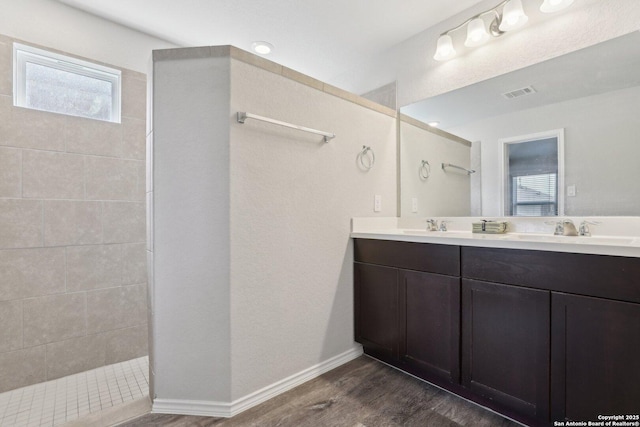 6131 Akin, San Antonio, TX 78261 - full bathroom featuring double vanity, wood finished floors, and walk in shower