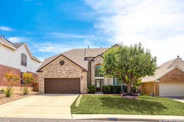 20926 Encino Pebble, San Antonio, TX 78259 - view of front of house featuring a garage, brick siding, concrete driveway, a front yard, and roof with shingles