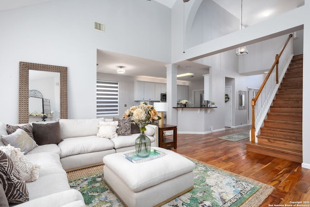 20926 Encino Pebble, San Antonio, TX 78259 - living area with a towering ceiling, wood finished floors, decorative columns, stairs, and baseboards