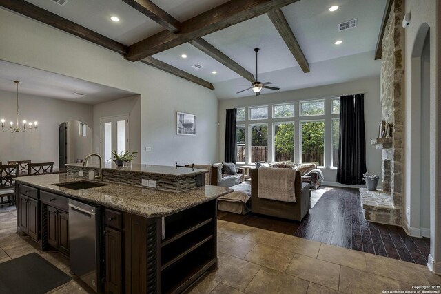 26358 Tawny Way, Boerne, TX 78015 - kitchen featuring a sink, dishwasher, arched walkways, ceiling fan, and beamed ceiling