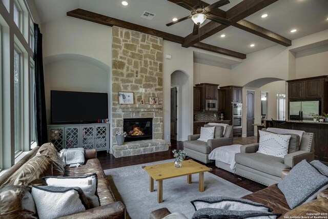 26358 Tawny Way, Boerne, TX 78015 - living area with beam ceiling, ceiling fan, arched walkways, a towering ceiling, and wood finished floors