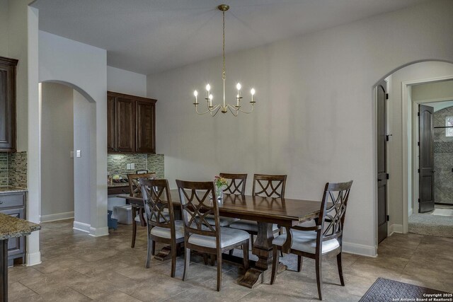 26358 Tawny Way, Boerne, TX 78015 - dining room featuring arched walkways, a chandelier, and baseboards