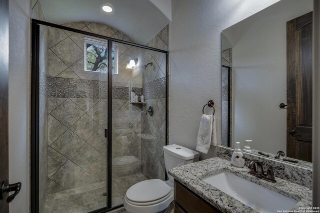 26358 Tawny Way, Boerne, TX 78015 - bathroom with vanity, toilet, a stall shower, and a textured wall