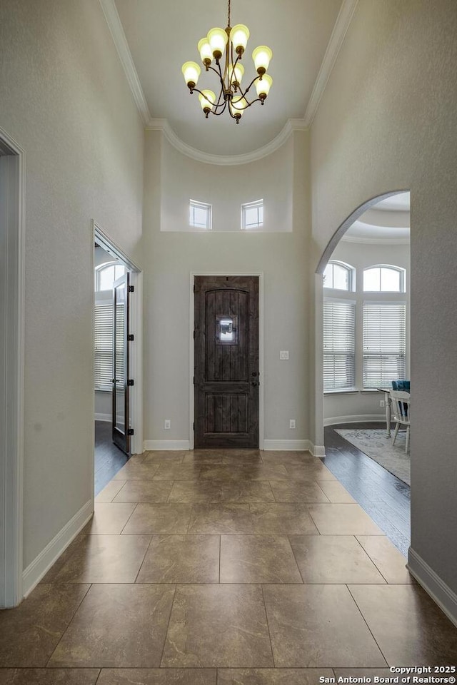 26358 Tawny Way, Boerne, TX 78015 - entryway featuring arched walkways, a chandelier, ornamental molding, baseboards, and a high ceiling