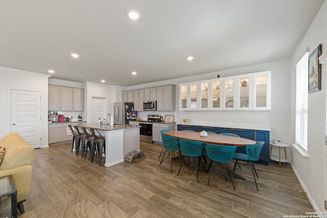 10815 Fox Trot, Converse, TX 78109 - kitchen featuring stainless steel appliances, a kitchen bar, light wood-style flooring, healthy amount of natural light, and recessed lighting