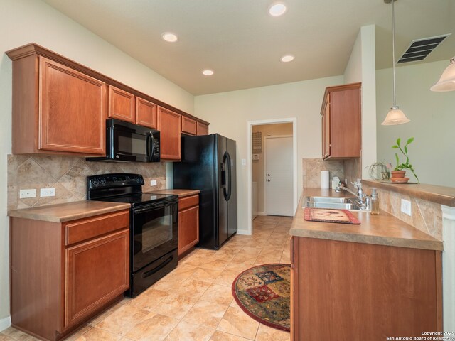 775 Guna Dr, New Braunfels, TX 78130 - kitchen with black appliances, a sink, tasteful backsplash, brown cabinets, and recessed lighting