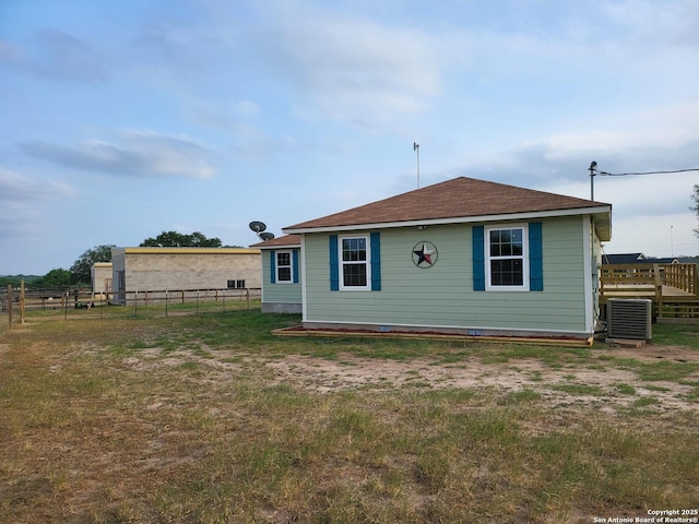 250 Krystal Ray Ln, Floresville, TX 78114 - rear view of house with central AC and roof with shingles