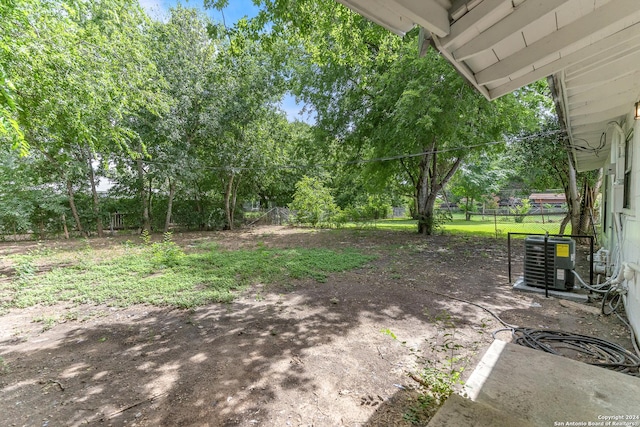 143 Langford, San Antonio, TX 78221 - view of yard featuring central air condition unit and view of wooded area