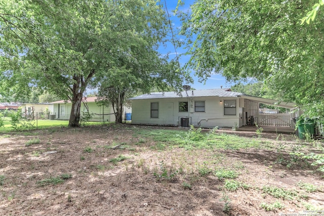 143 Langford, San Antonio, TX 78221 - rear view of property featuring central AC unit, metal roof, and an attached carport