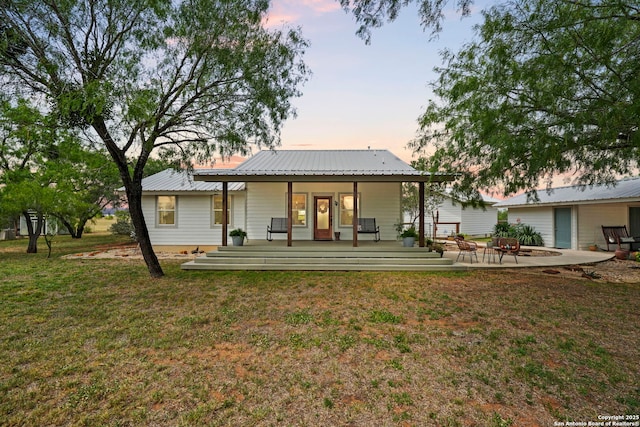 14834 Fm 536, Pleasanton, TX 78064 - back of property at dusk with a yard and metal roof