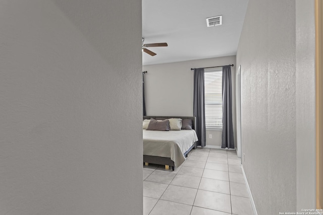 8415 Fortuna Vly, San Antonio, TX 78252 - bedroom with light tile patterned flooring, baseboards, a ceiling fan, and a textured wall