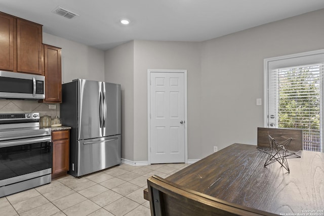 8415 Fortuna Vly, San Antonio, TX 78252 - kitchen featuring stainless steel appliances, light tile patterned floors, baseboards, tasteful backsplash, and recessed lighting