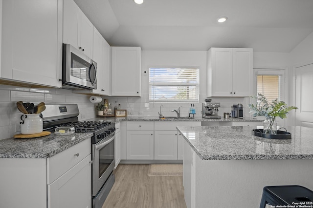 31665 Acacia Vis, Bulverde, TX 78163 - kitchen featuring appliances with stainless steel finishes, a sink, white cabinets, light stone countertops, and recessed lighting