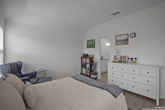 31665 Acacia Vis, Bulverde, TX 78163 - bedroom with wood finished floors, lofted ceiling, and connected bathroom