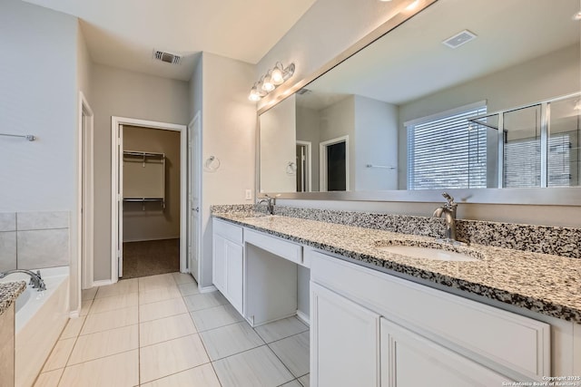 13908 Lazada, San Antonio, TX 78245 - bathroom featuring double vanity, tile patterned flooring, a garden tub, a stall shower, and a spacious closet