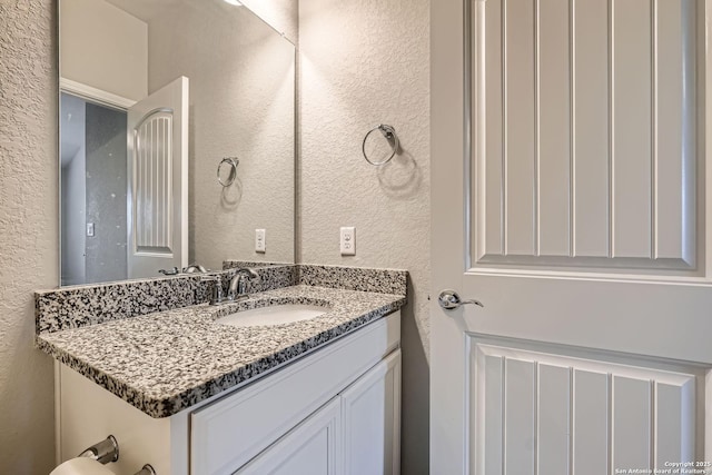 13908 Lazada, San Antonio, TX 78245 - bathroom featuring a textured wall and vanity
