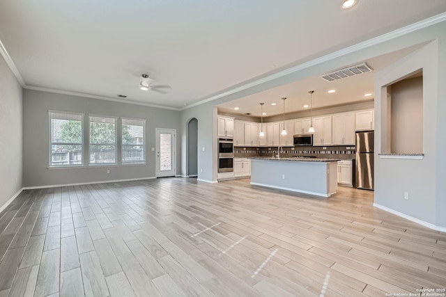 13908 Lazada, San Antonio, TX 78245 - kitchen with stainless steel appliances, open floor plan, a ceiling fan, white cabinets, and crown molding