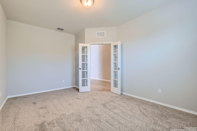 13908 Lazada, San Antonio, TX 78245 - empty room with french doors, carpet, and baseboards