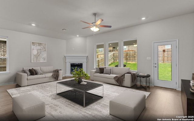 1632 Bonhill Yard, New Braunfels, TX 78130 - living room with a ceiling fan, wood finished floors, a glass covered fireplace, recessed lighting, and baseboards