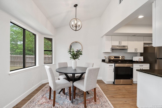 7527 Rustic Trl, San Antonio, TX 78244 - dining room featuring light wood finished floors, a chandelier, and baseboards