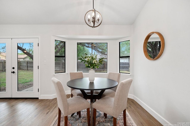 7527 Rustic Trl, San Antonio, TX 78244 - dining room with baseboards, wood finished floors, a chandelier, and french doors