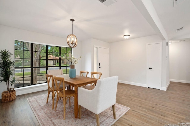7527 Rustic Trl, San Antonio, TX 78244 - dining room with light wood-type flooring, baseboards, and a chandelier