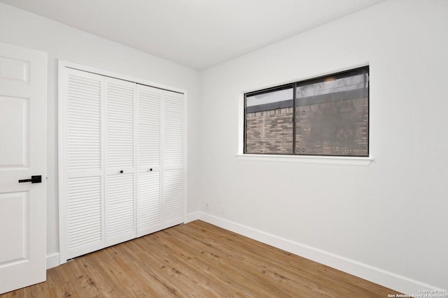 7527 Rustic Trl, San Antonio, TX 78244 - unfurnished bedroom with light wood-type flooring, baseboards, and a closet