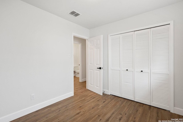 7527 Rustic Trl, San Antonio, TX 78244 - unfurnished bedroom with wood finished floors, baseboards, and a closet