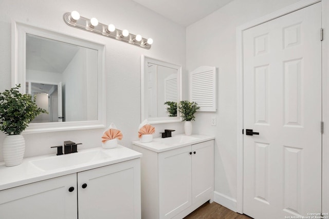 7527 Rustic Trl, San Antonio, TX 78244 - bathroom with two vanities and wood finished floors