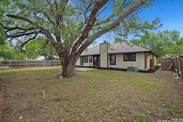 7527 Rustic Trl, San Antonio, TX 78244 - rear view of house with cooling unit and a patio area