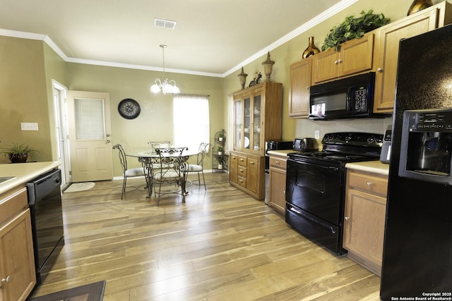 3322 Dunlap Flds, Converse, TX 78109 - kitchen with black appliances, crown molding, light countertops, light wood-type flooring, and a chandelier