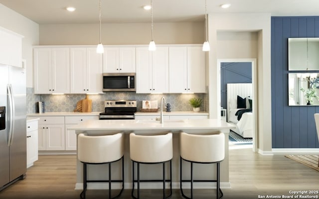 6422 Penny Path, San Antonio, TX 78253 - kitchen featuring appliances with stainless steel finishes, a sink, light wood-style floors, light countertops, and recessed lighting
