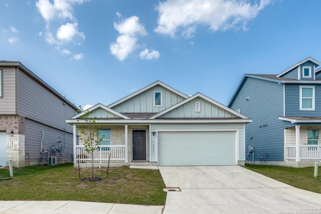 10827 Hernando Ct, Converse, TX 78109 - view of front of property with board and batten siding, covered porch, an attached garage, concrete driveway, and a front lawn