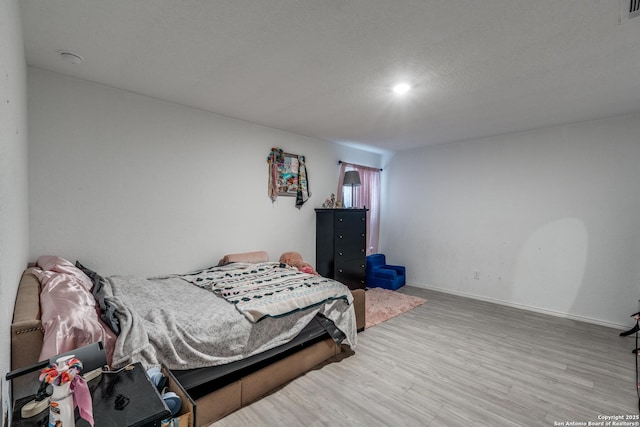 10827 Hernando Ct, Converse, TX 78109 - bedroom with wood finished floors and baseboards
