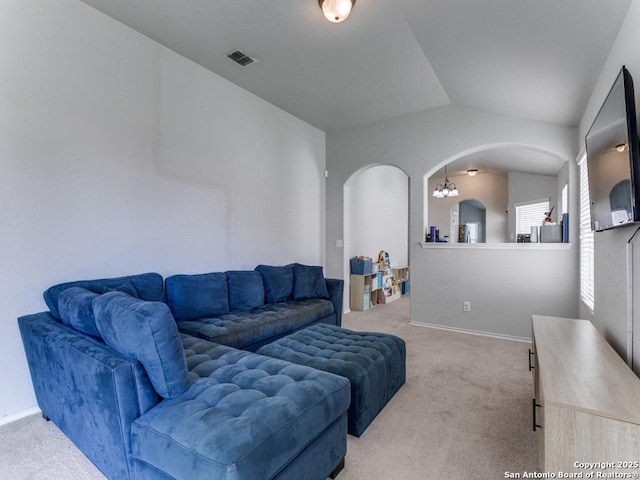 6211 Post Mi, San Antonio, TX 78244 - living room featuring arched walkways, light carpet, vaulted ceiling, and baseboards