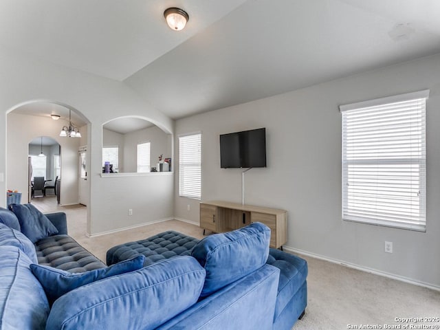 6211 Post Mi, San Antonio, TX 78244 - living area featuring arched walkways, light carpet, healthy amount of natural light, vaulted ceiling, and baseboards