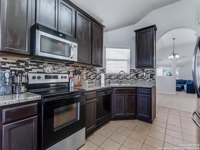6211 Post Mi, San Antonio, TX 78244 - kitchen featuring stainless steel appliances, lofted ceiling, a sink, light tile patterned flooring, and backsplash